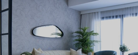 A furnished interior with curtains and greenery